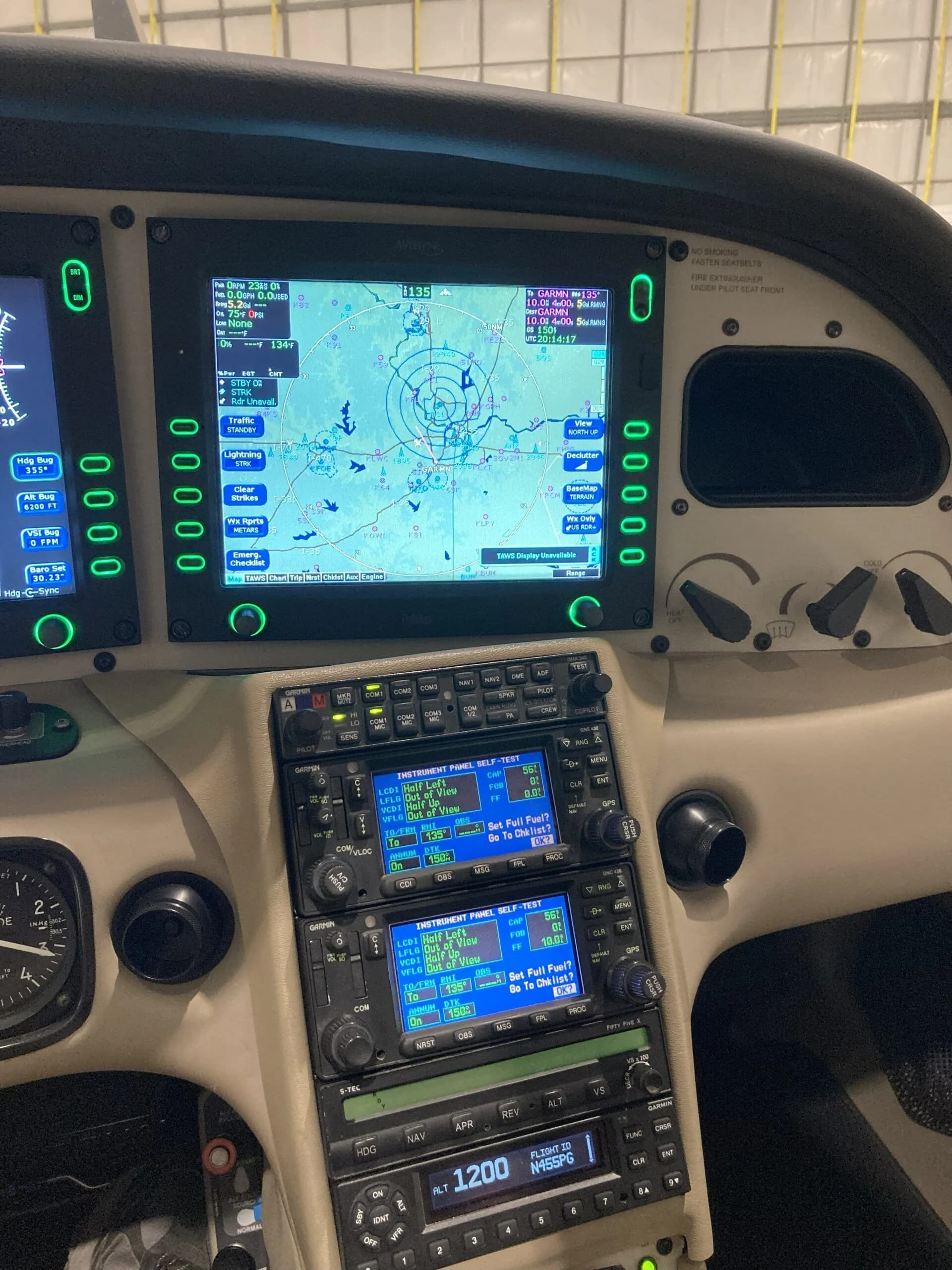 Close-up of the right display screen and avionics stack in the cockpit of a Cirrus SR22 aircraft.