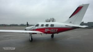 A Piper PA46-350P Mirage, registration SP-NAZ, parked on the tarmac.