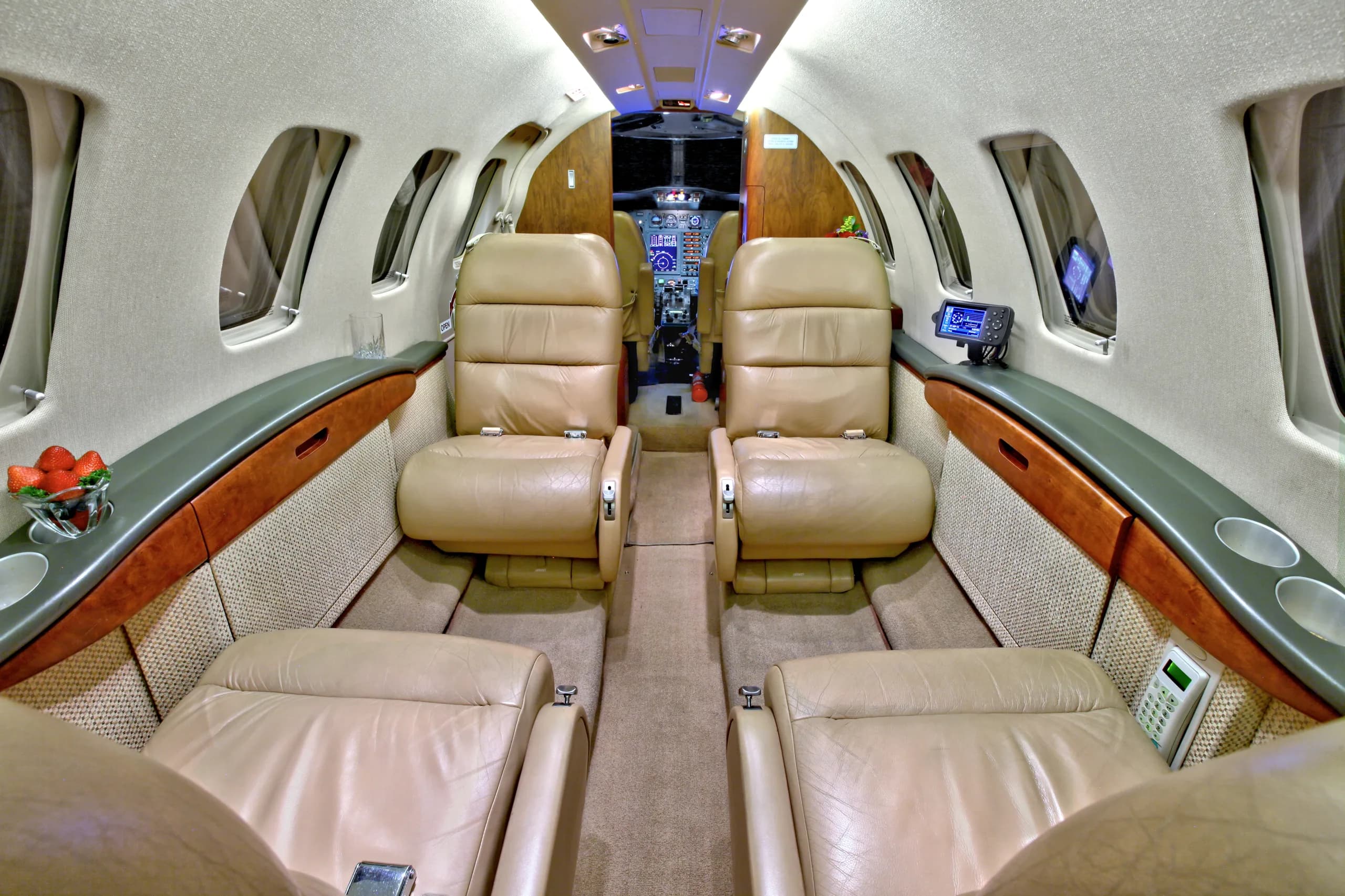 The interior of a Cessna Citation CJ1+ featuring leather seats and a view towards the cockpit.