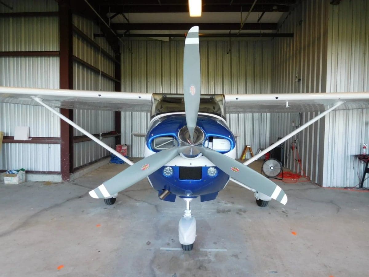 Front view of the N699JG Cessna aircraft inside a hangar.