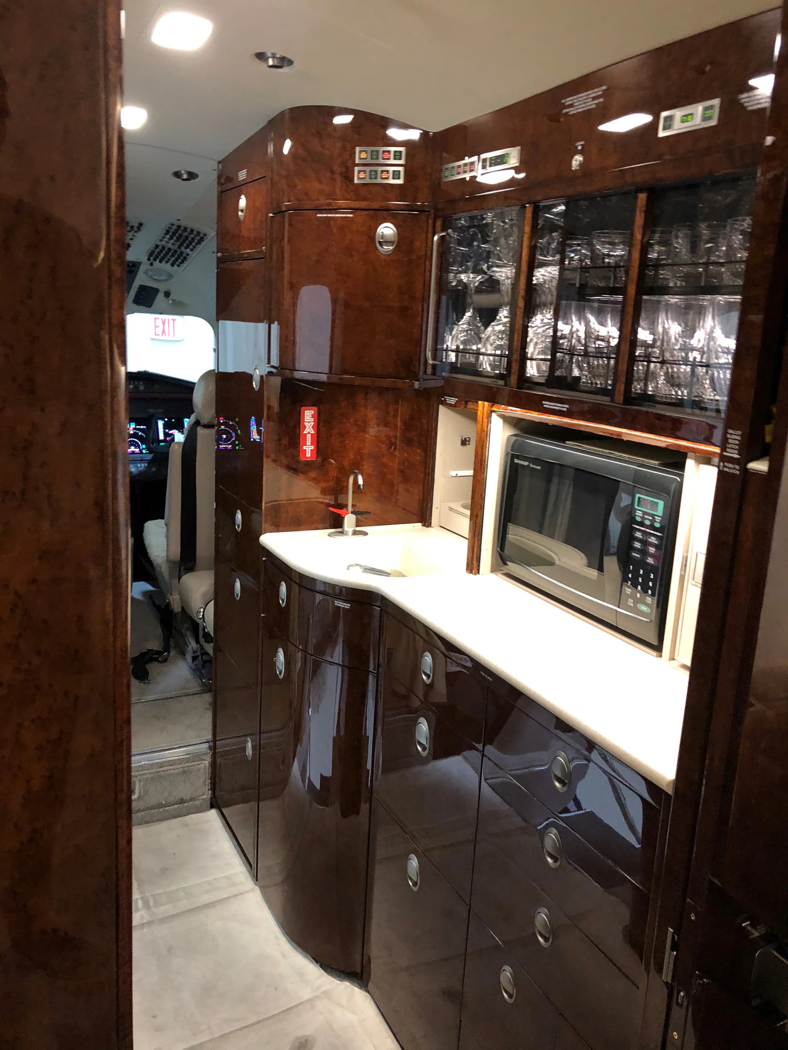 A view of the aircraft's galley, featuring a microwave and storage cabinets.