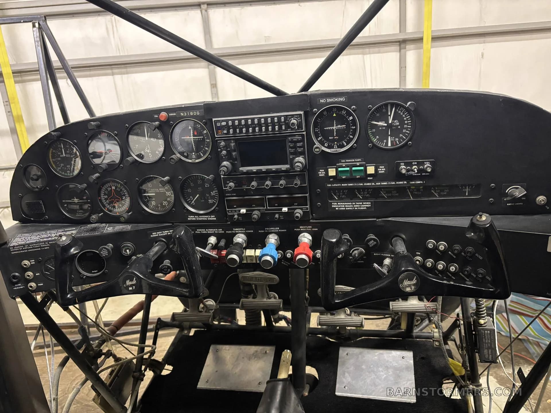 A full view of a Maule M-7 aircraft cockpit, showing the instrument panel, yokes, and pedals.