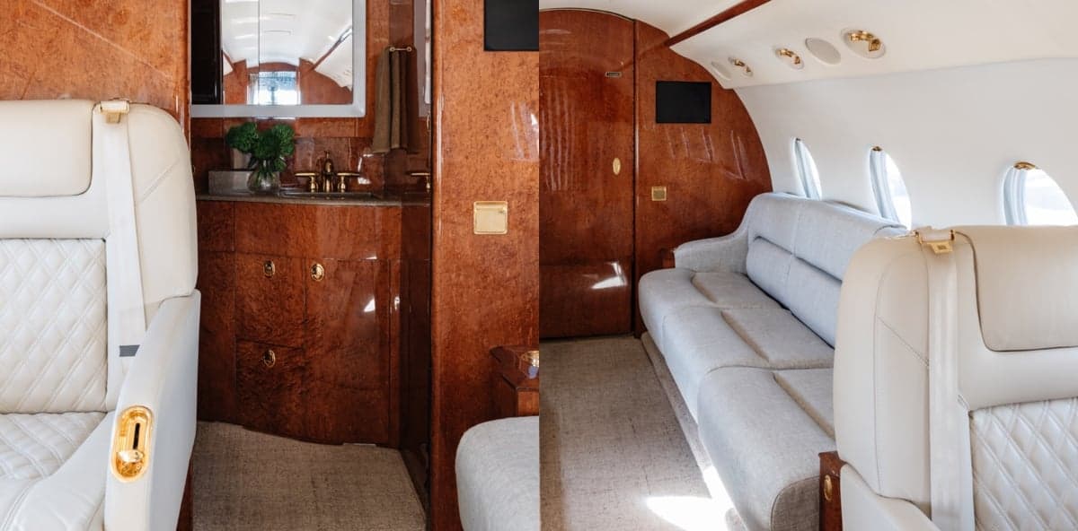 Interior view of the aircraft cabin featuring a lavatory and seating area.