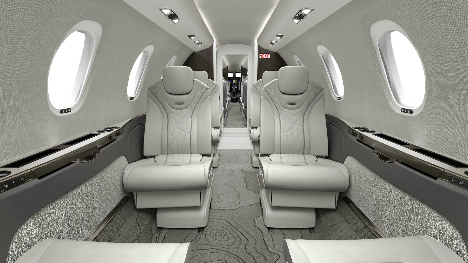View of the aircraft's interior cabin with white leather seats.