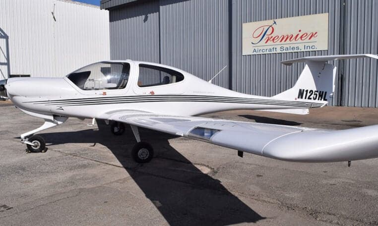Side view of a Diamond DA40 aircraft with registration N125HL parked on the tarmac.