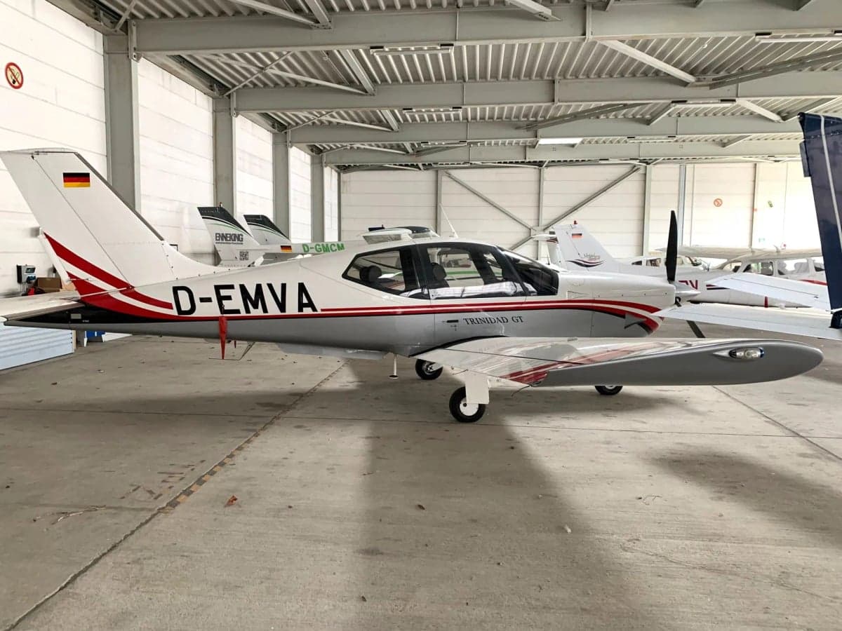 D-EMVA Trinidad GT aircraft in a hangar, side view.