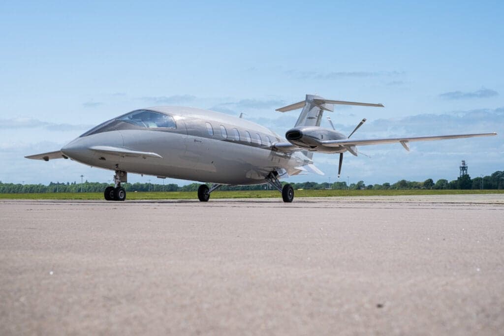 Side front view of a Piaggio Avanti EVO aircraft on the tarmac.