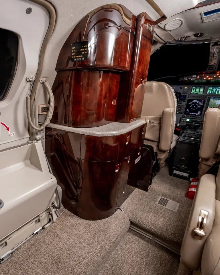 View of the aircraft interior showing a refreshment center and cockpit.