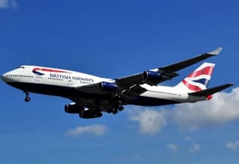 A British Airways Boeing 747 in flight against a blue sky.