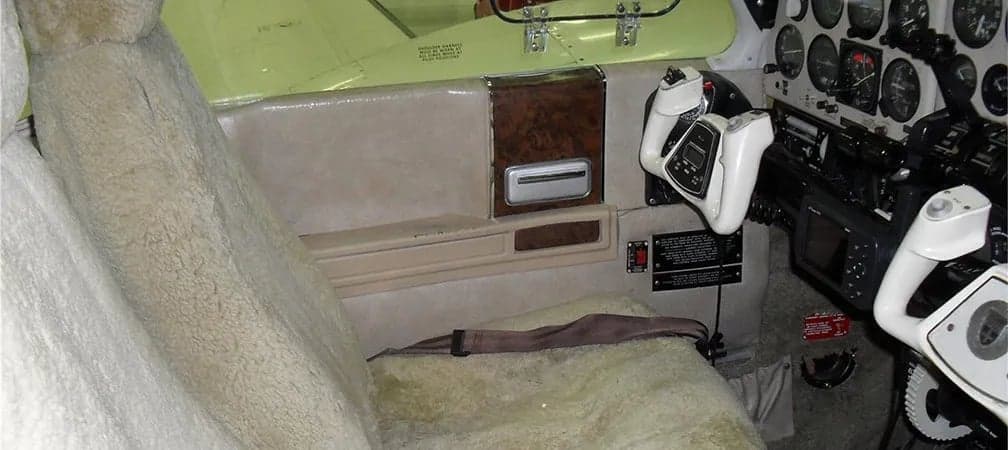 View of the aircraft's cockpit and sheepskin-covered seat.
