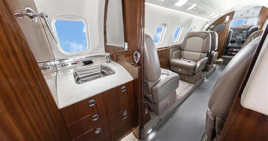 Aircraft cabin with lavatory and seats.