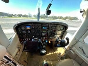 A wide view of the Cessna 182 Skylane cockpit, showing the instrument panel and controls.