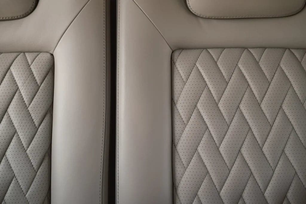 Close-up of the leather seats inside the aircraft cabin.
