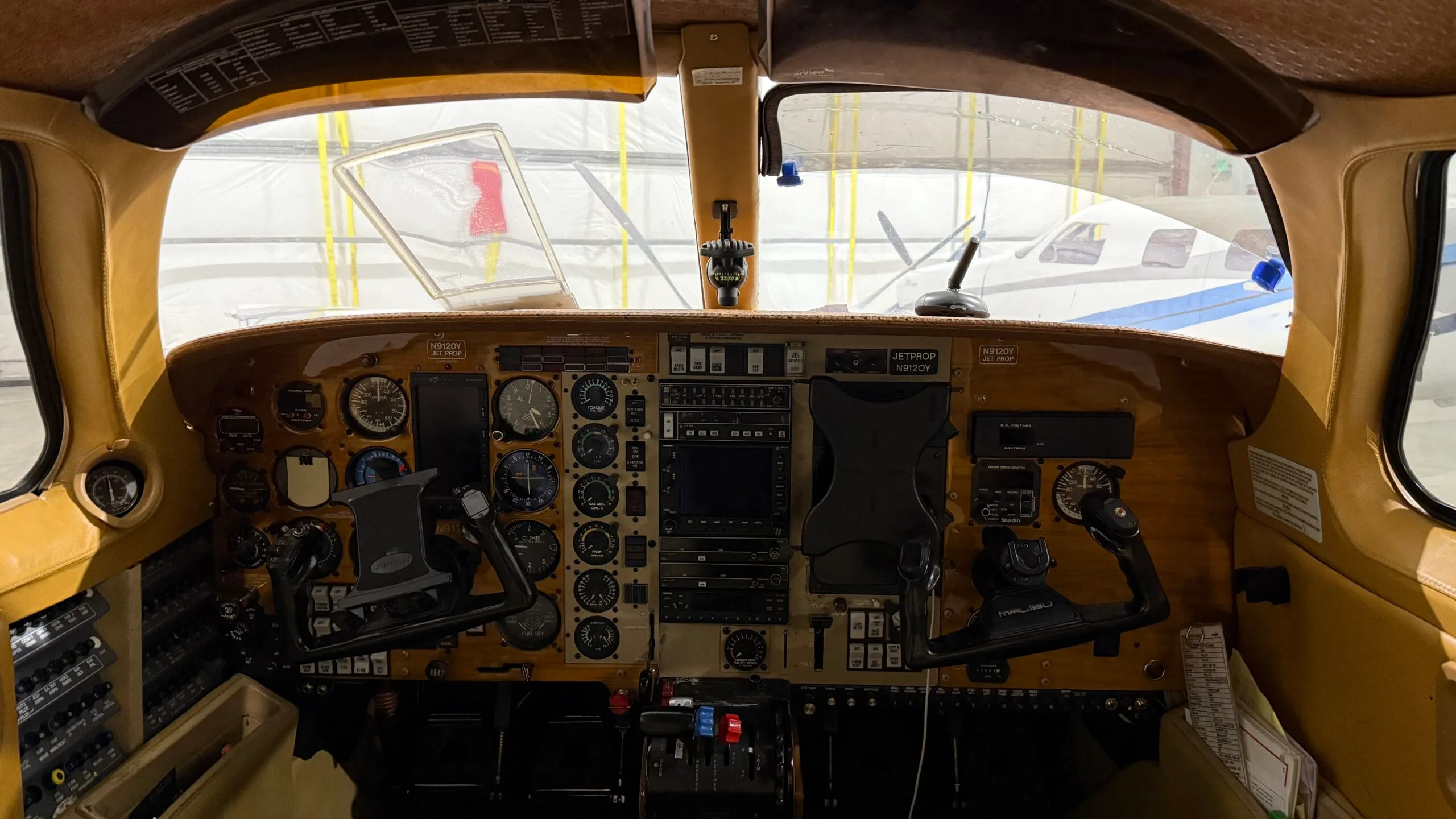 View of the aircraft cockpit with instrument panel and yokes.
