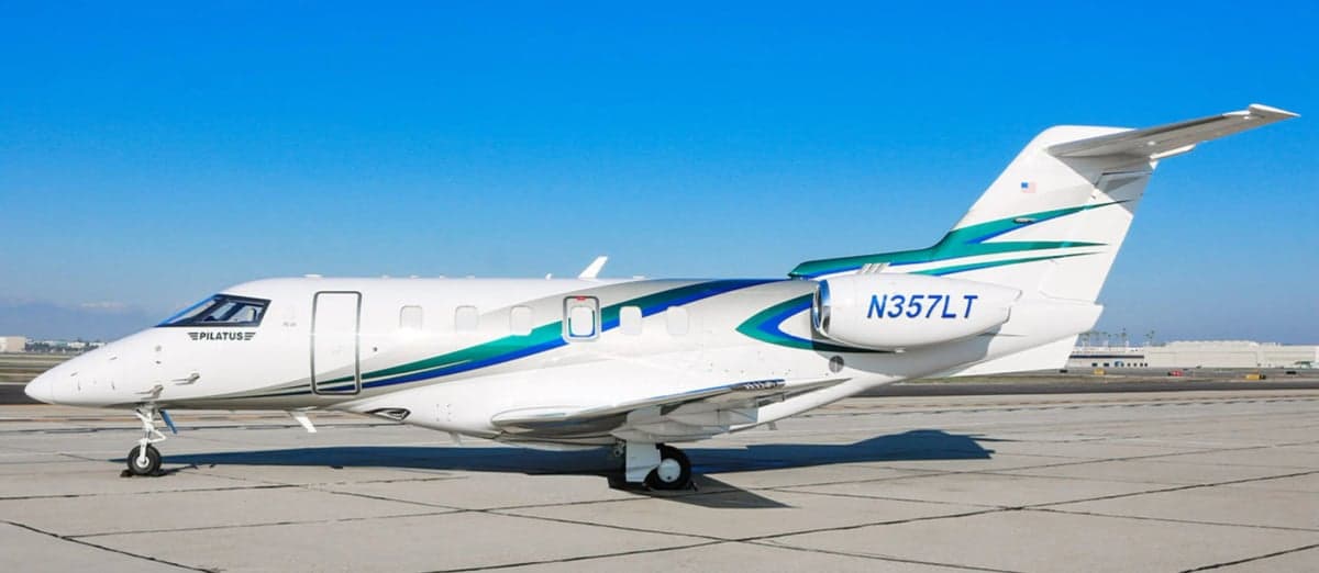 Pilatus PC-24 N357LT parked on the tarmac with a white and teal paint scheme.