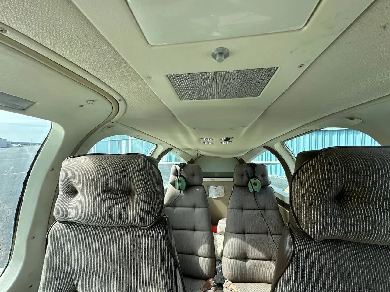 View of the aircraft's interior seats and ceiling.