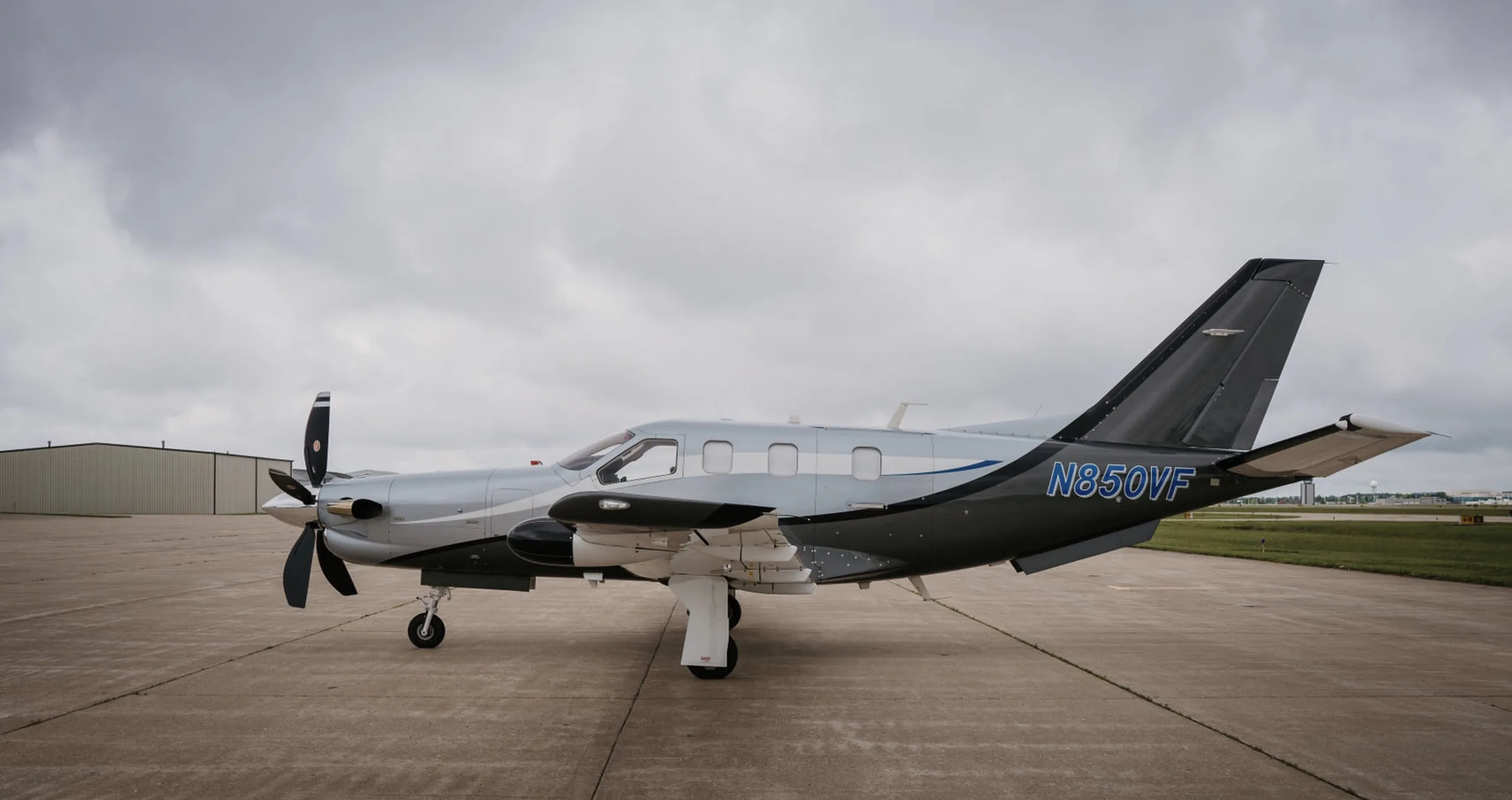 Side view of the N850VF aircraft on the tarmac with a gray and silver paint scheme.