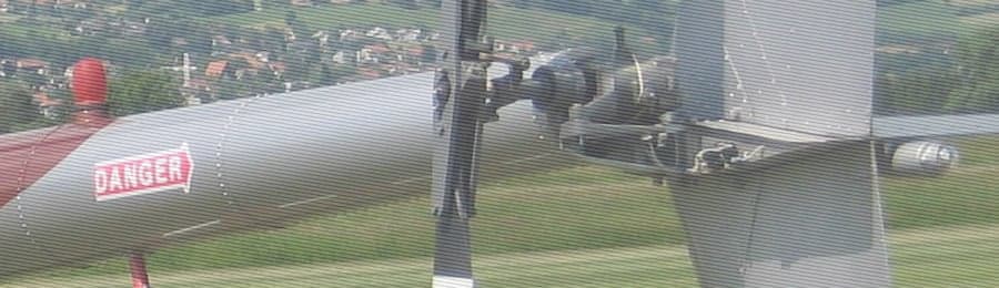 Close-up of a helicopter tail rotor with a red 'DANGER' marking.