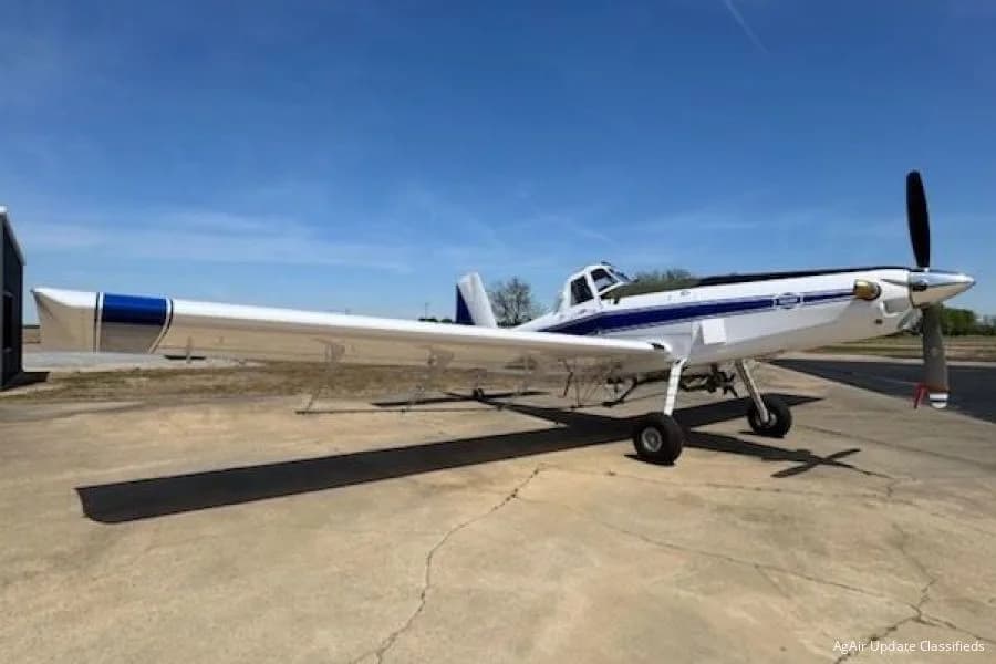 A white and blue Air Tractor AT-502 on the ground.