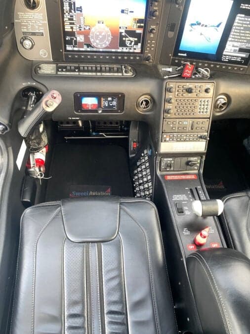 The cockpit of a Cirrus aircraft features a modern avionics suite and comfortable seating.
