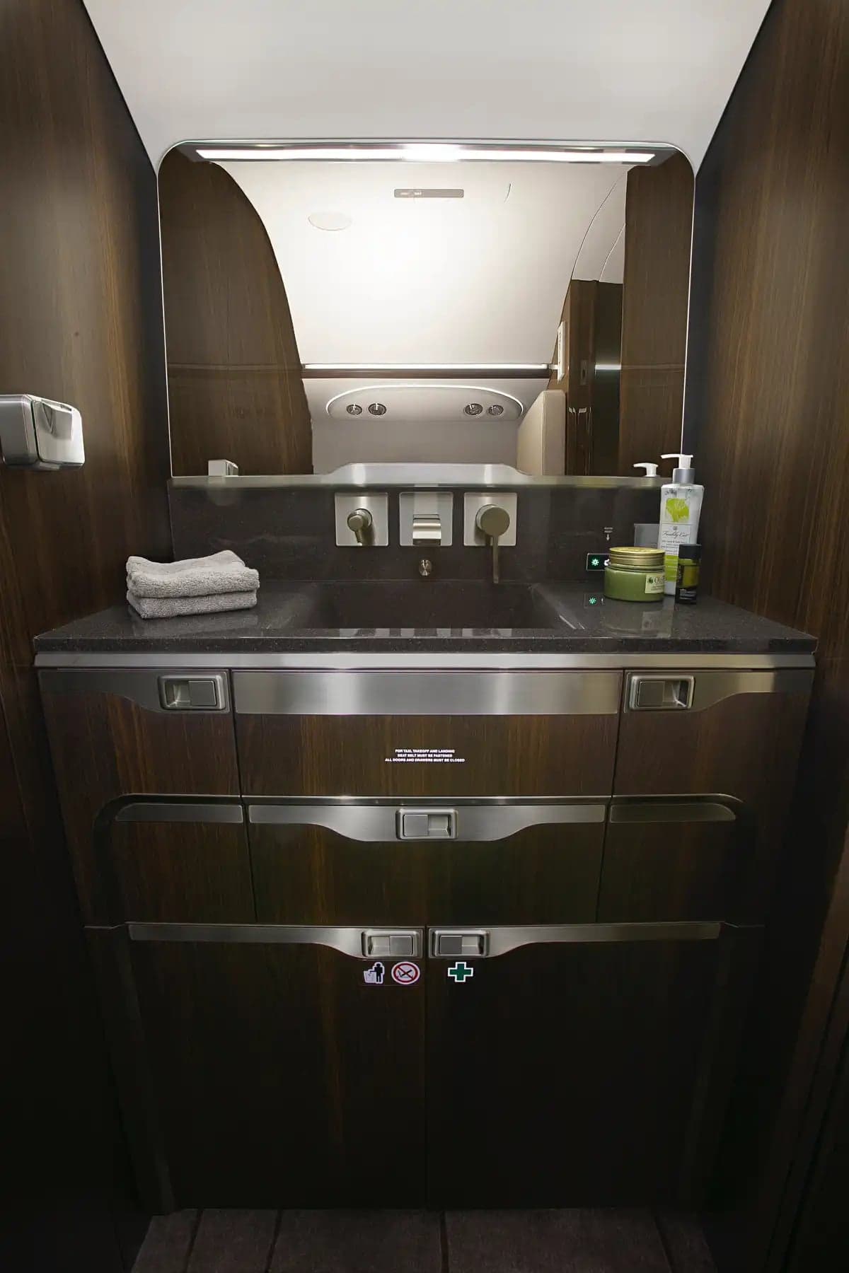 Interior view of the aircraft's lavatory with a sink and storage.