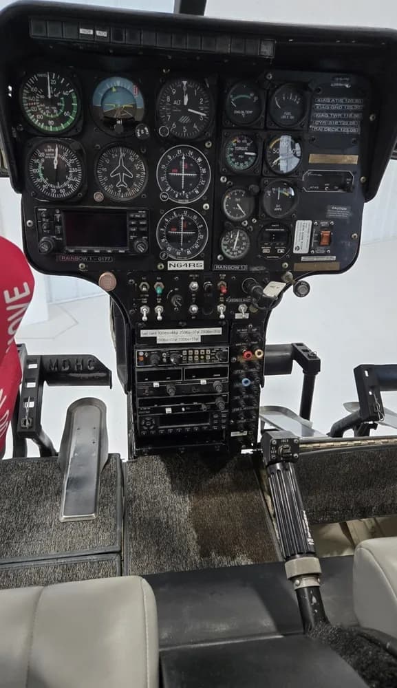 A detailed view of the helicopter's instrument panel with various gauges and controls.