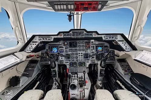 The cockpit of a jet aircraft with a full instrument panel.