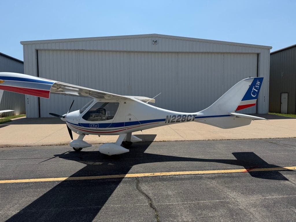 Side view of a CTLSW aircraft with registration N228CT parked on the tarmac.