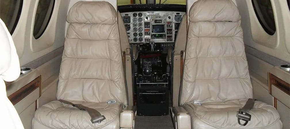View of the aircraft's cabin seats and cockpit.