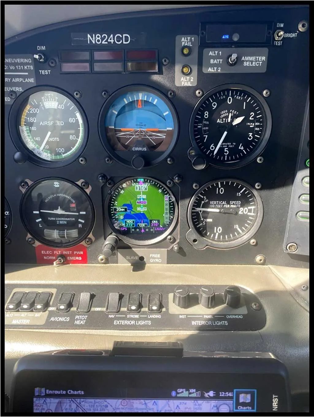 A close-up view of the Cirrus SR20 aircraft's instrument panel, displaying various gauges, a digital screen, and the N824CD registration.