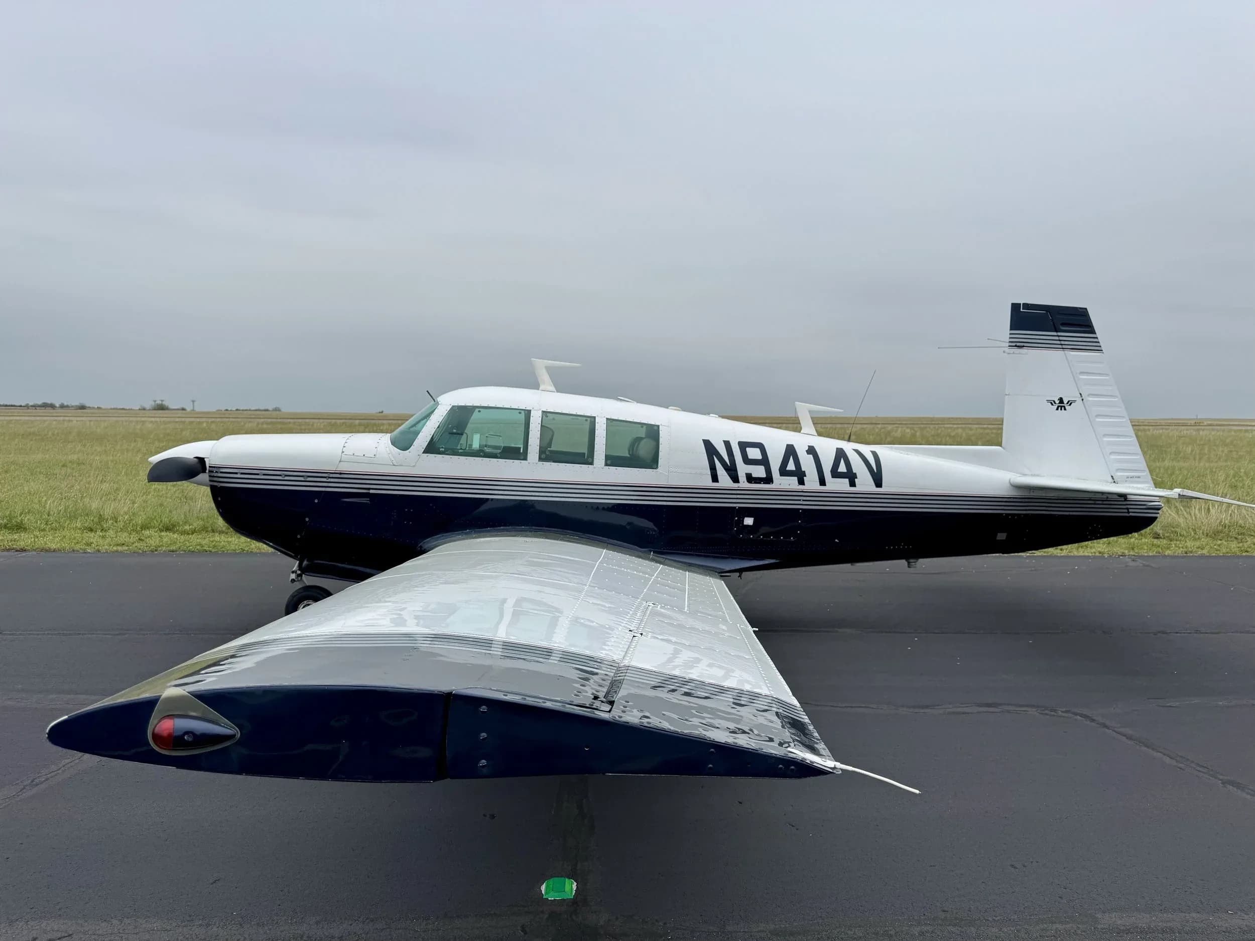 A Beechcraft Bonanza aircraft with registration N9414V is parked on the tarmac.