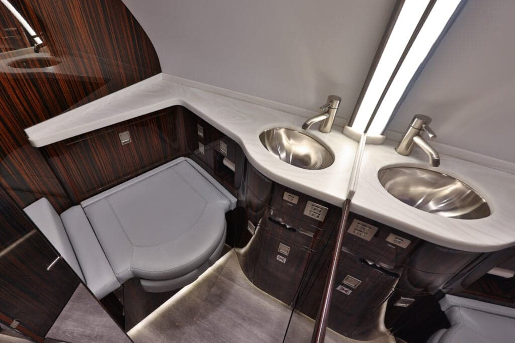 View of the aircraft lavatory featuring a sink and toilet.