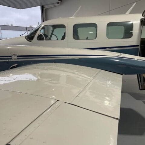 Close-up of the wing and fuselage of a Piper PA-31 Navajo.