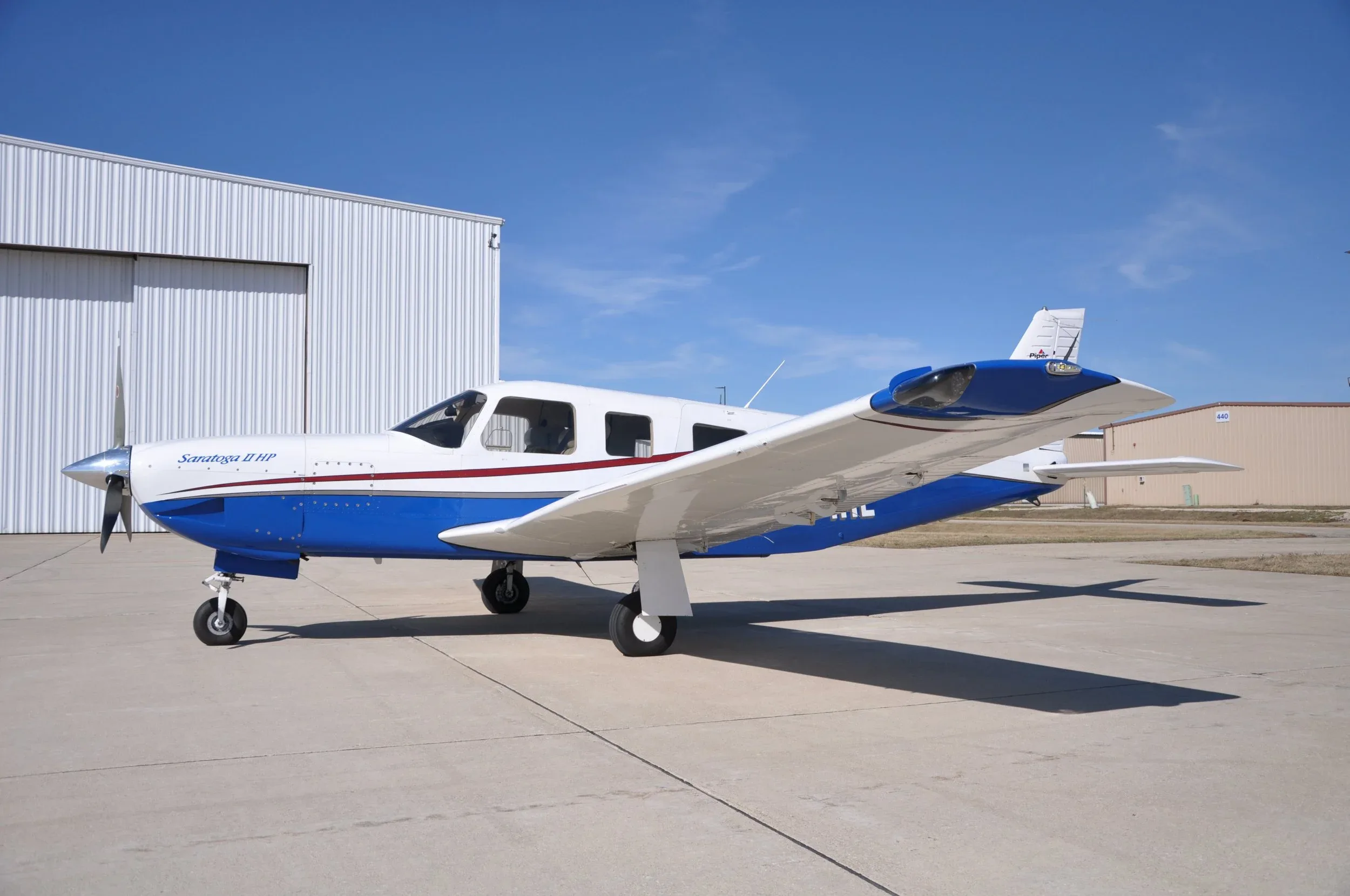 A Saratoga II HP aircraft with registration N71RL is parked on the tarmac.