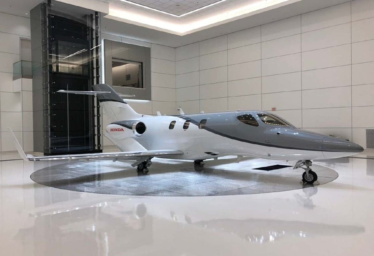 A HondaJet on display in a showroom setting.