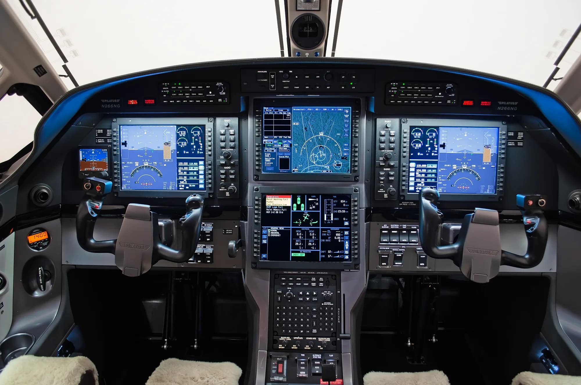The modern glass cockpit of a Pilatus PC-12 NG aircraft, featuring multiple digital displays and controls.