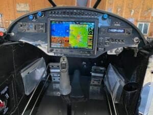 The cockpit of the aircraft features a large display screen and various controls.