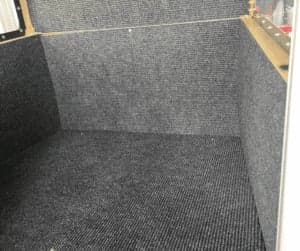 The interior of the aircraft is carpeted with gray material.