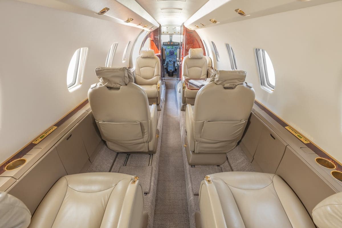 View of the aircraft cabin with tan leather seats.