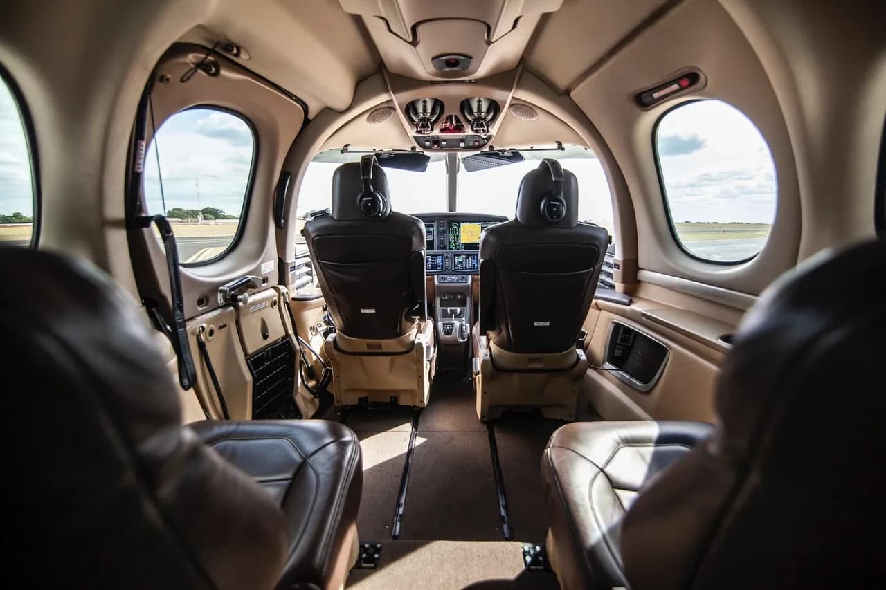 A view from the rear cabin of a Cirrus Vision Jet looking forward into the cockpit.