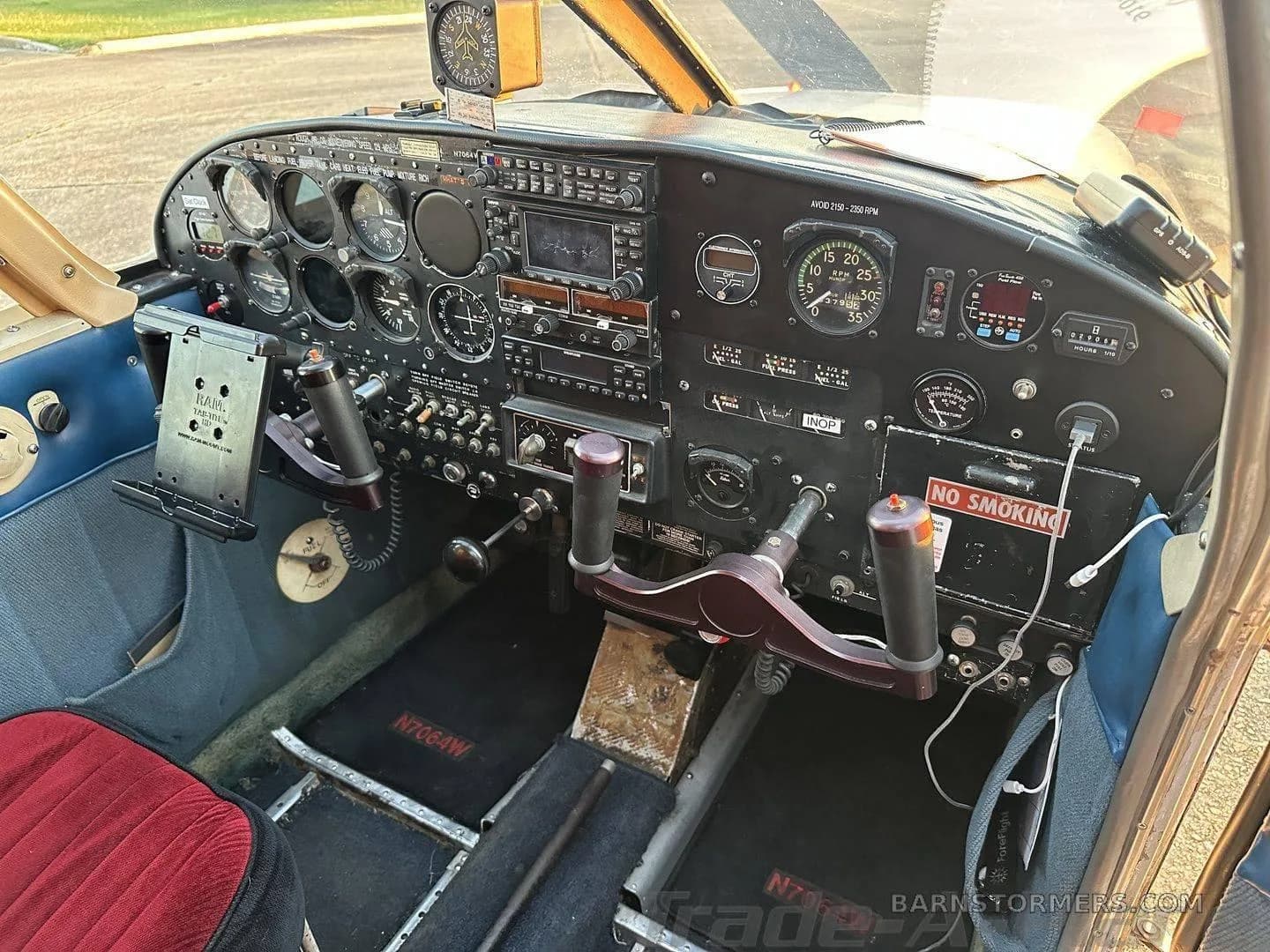 A detailed view of the aircraft's instrument panel with various gauges, radios, and control yokes.