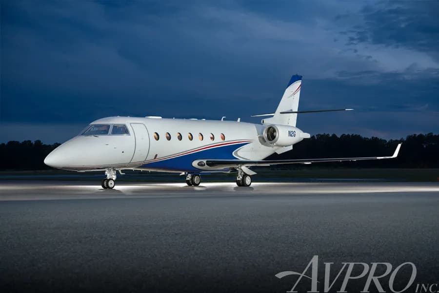 A Gulfstream G200 business jet, tail number N2G, parked on a tarmac at dusk.