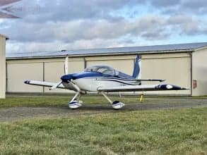 A blue and white aircraft is parked on the ground.