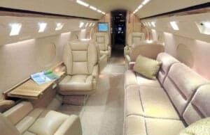 The interior of the aircraft features leather seats and a sofa.