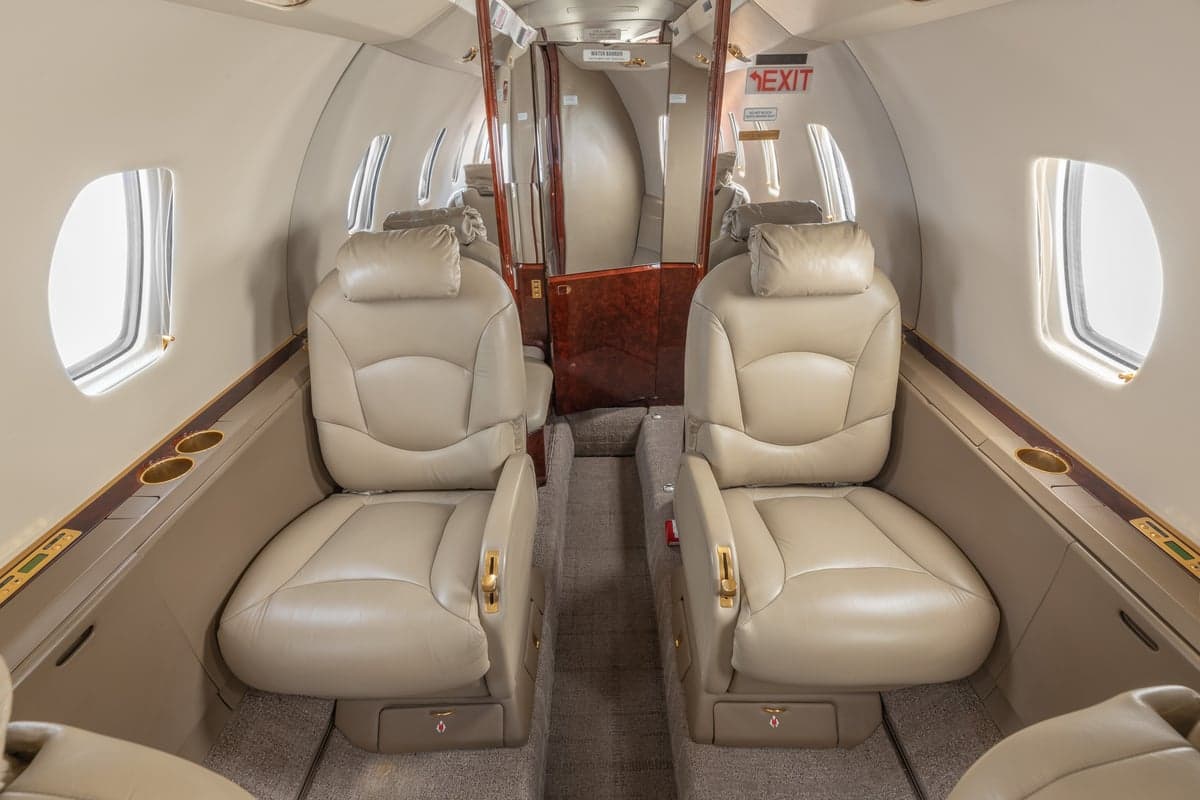 View of the aircraft cabin with tan leather seats.