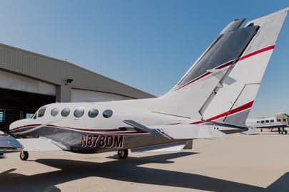 Close up of the open baggage compartment of a Beechcraft aircraft.