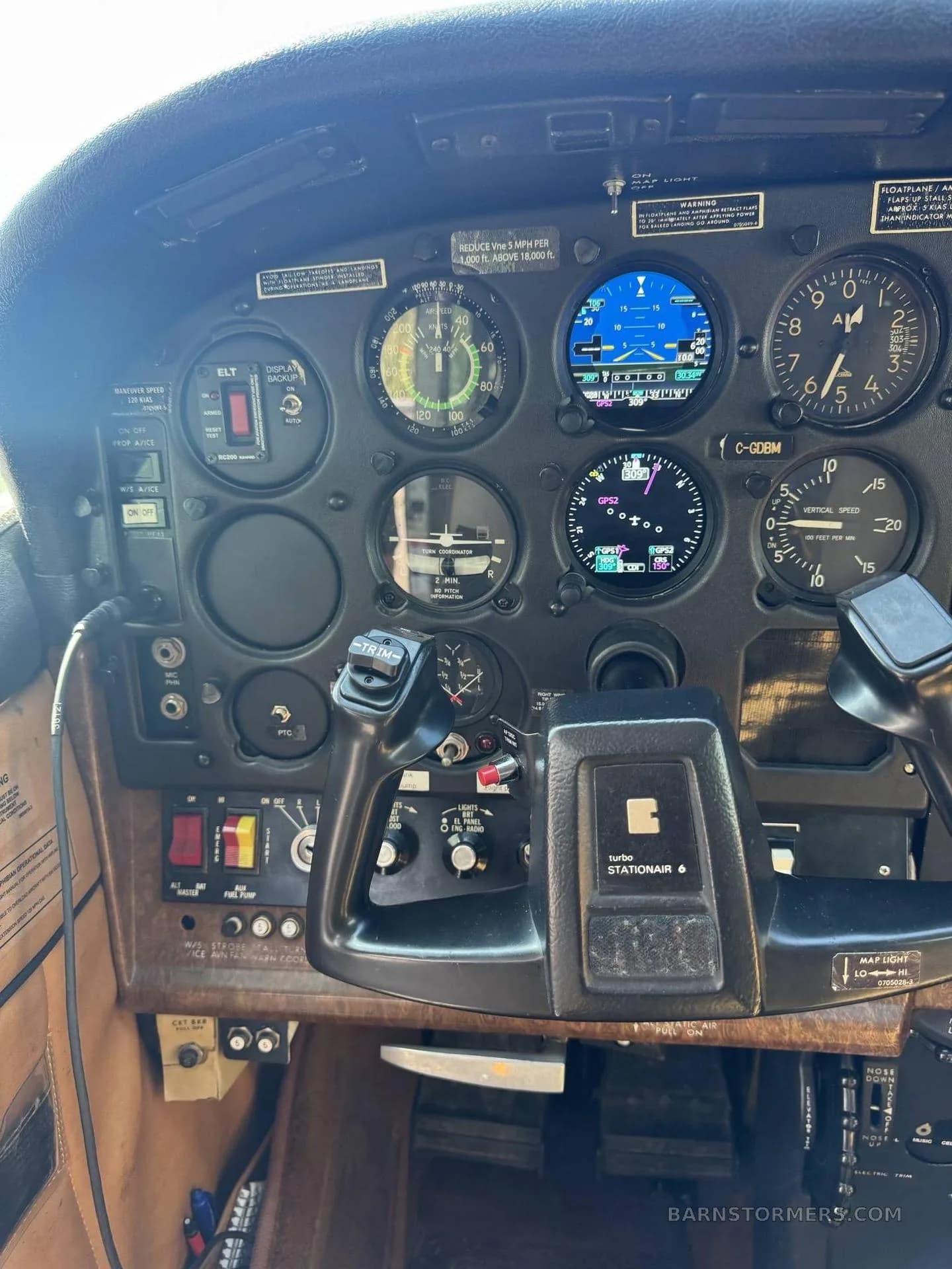 A close-up of the left side of the Cessna Stationair 6 instrument panel, including the pilot's yoke and various gauges.