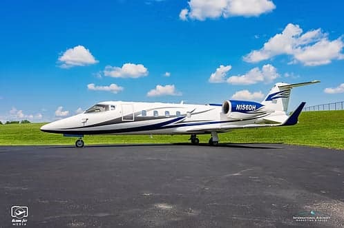 A Learjet 45XR, registration N156DH, parked on the tarmac.
