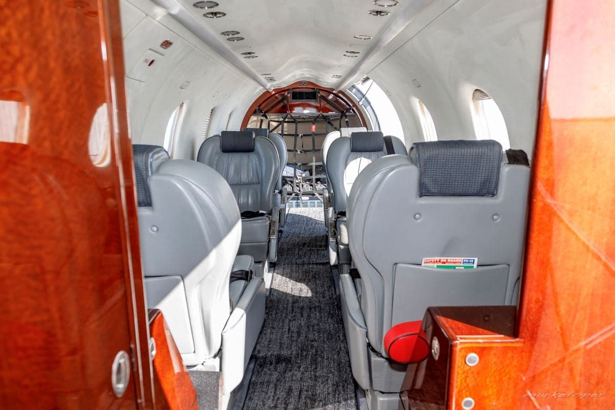 View of the Pilatus PC-12 cabin interior with gray leather seats.