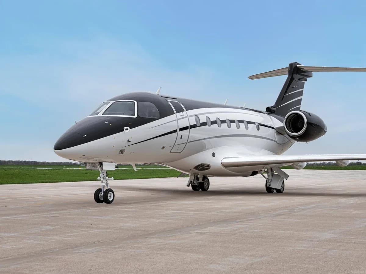 A business jet is parked on the tarmac.